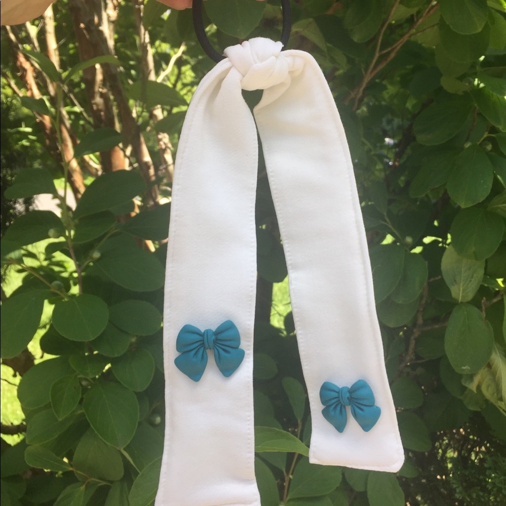 White hair tie with blue bow. Hair tie with tail
